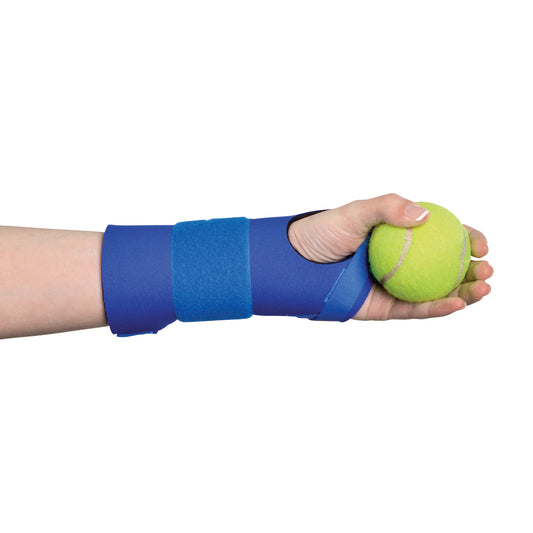 A hand wears the AliMed FREEDOM Neoprene CTS Grip-Fit Splint, holding a green tennis ball, illustrating its supportive design.